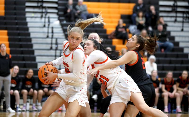 St. Charles East's Alyse Price grabs a rebound during a game against Wheaton Warrenville South on Tuesday, Feb. 11, 2025 in St. Charles.