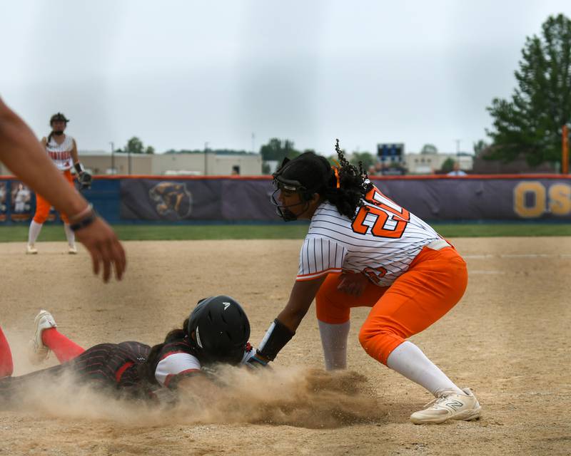 Yorkville's Liv Lathen, left, slides into home plate and was ruled safe as Oswego's Jaelynn Anthony (20) puts the tag on during the sectional semifinal game on Tuesday June 3, 2025, held at Oswego High School.