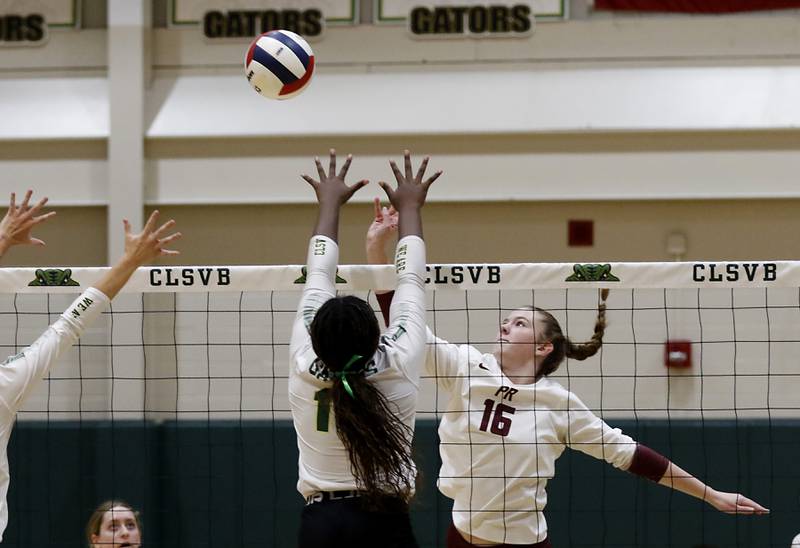 Prairie Ridge's Adeline Grider tips the ball over Crystal Lake South's Sahara Okiria during the IHSA Class 3A Crystal Lake South Sectional final volleyball match on Thursday, Nov. 7, 2024, at Crystal Lake South High School.