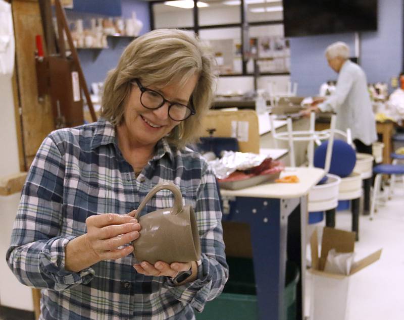 Susan Clough makes a mug after her advance ceramics class on Thursday, Feb, 6, 2025, at McHenry County College.