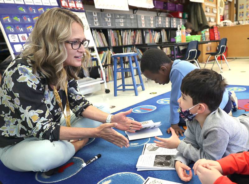 Littlejohn Elementary School kindergarten teacher Tracy Paszotta talks to Liam Alvarez during small group time in class Monday, March 28, 2022, at the school in DeKalb.