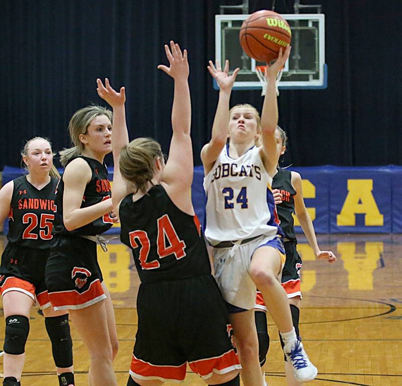Somonauk's Katelyn Curtis (24) runs into the lane to shoot a basket as Sandwich's Breanna Sexton (24) defends in the Tim Humes Breakout Tournament on Friday, Nov. 18, 2022 in Somonauk.