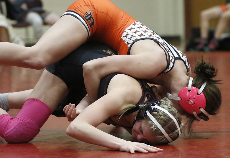DeKalb’s Reese Zimmer tries to turn Morris’ Zara Lugo in the 125-pound match of a nononference wrestling meet on Wednesday, Jan. 22, 2025, at Huntley High School.