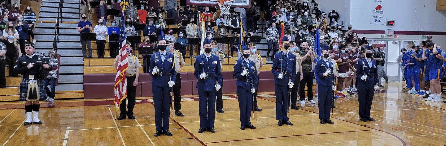 Chicago Police Bagpiper Tom Gallas, Tinley Park VFW Honor Guard and Lincoln Way AFROTC Saber Team stand in formation prior to the playing of the National Anthem at Lockport Township High School during the seventh annual Veterans Appreciation Night on Friday, Feb. 4, 2022.