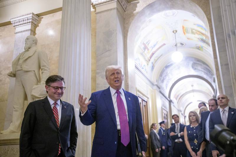 President Donald Trump, right, is joined by Speaker of the House Mike Johnson, R-La., as he arrives for a meeting with the House Republican Conference at the Capitol, Tuesday, May 20, 2025, in Washington. (AP Photo/Rod Lamkey, Jr.)
