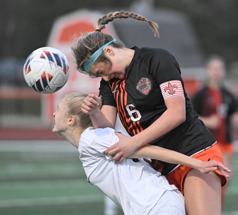 St. Charles East’s Mackenzie Loomis goes over the back of Fremd’s Gwen Zimmerman in a girls soccer game in St. Charles on Tuesday, March 12, 2024.