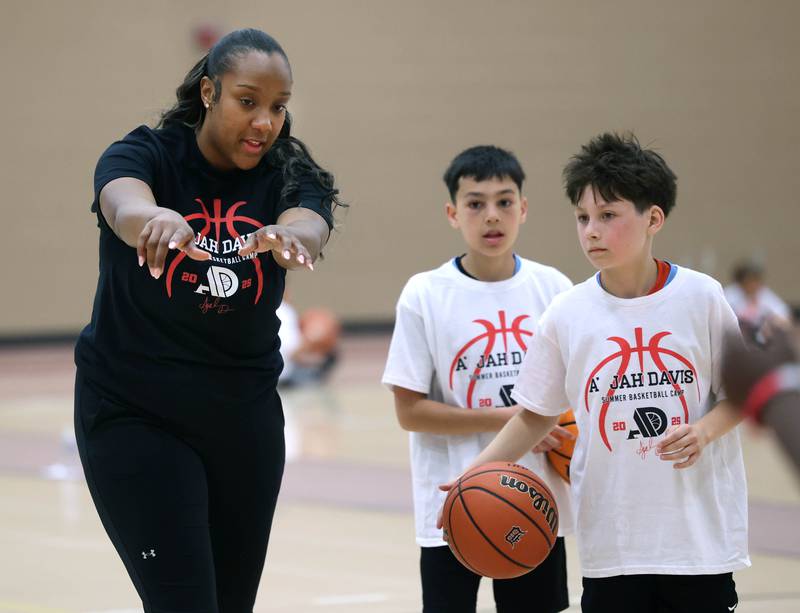 DeKalb native and former Northern Illinois University basketball player A'Jah Davis gives some instruction during a drill Saturday, May 24, 2025, at her A'Jah Davis Foundation Basketball Camp and Wellness Day at DeKalb High School.
