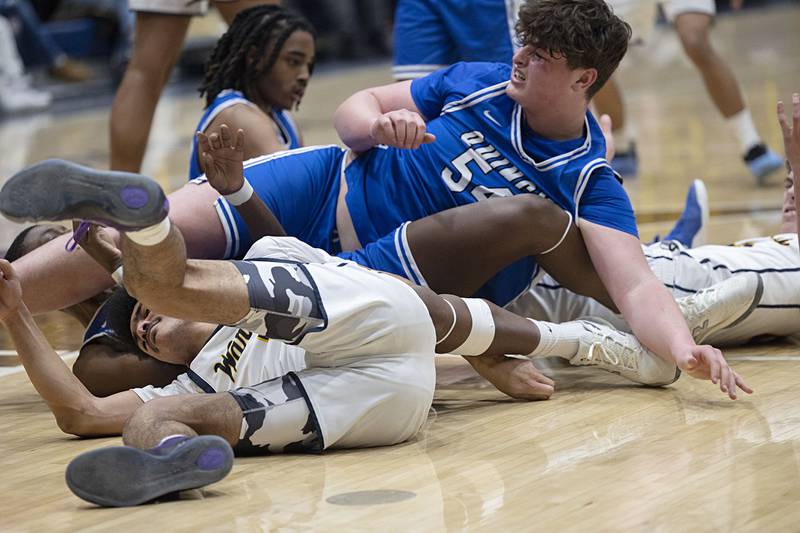 Several Sterling and Quincy players go down in a heap Friday, Jan. 30, 2026 during basketball action at Sterling High School.