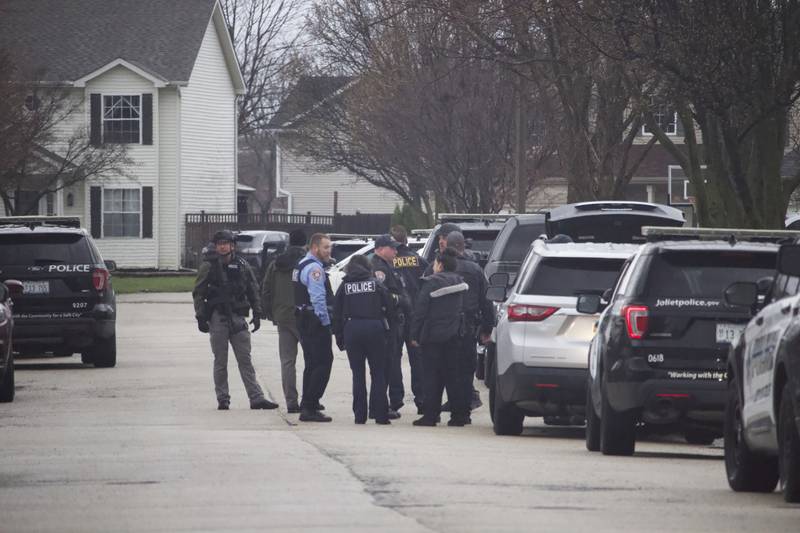 Joliet police officers gather on April 2, 2025, in the area of Meadowbrook Street and Lasser Drive in the far west side of joliet.
