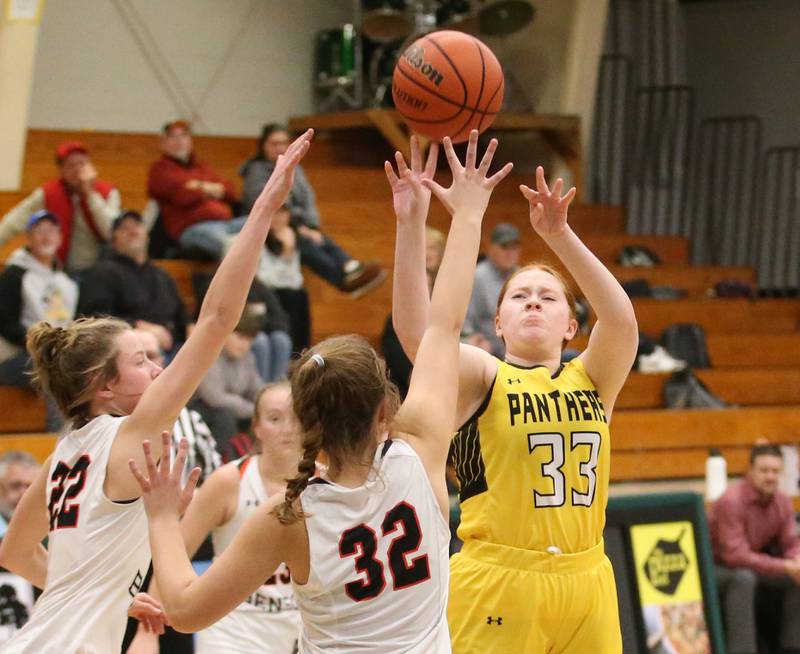 Putnam County's Emma Henderson shoots a jump shot over Roanoke-Benson's Brianna Harms and Avery Alford during the Tri-County Conference Tournament on Tuesday, Jan. 17, 2023 at Midland High School.