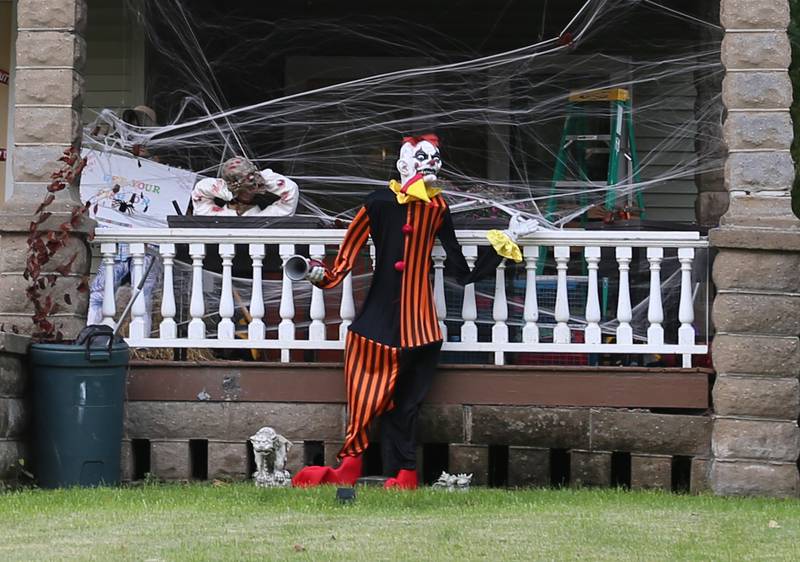 A scary clown stands outside the porch of this home in the 800 block of Ottawa Avenue on Thursday, Oct. 12, 2023 in Ottawa.
