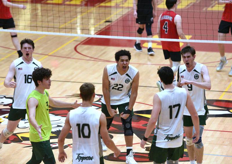 Glenbard West's Danny Dorsey (16), Xavion Willett (22) and Gavin Swartz (9) let out a shout to teammates on their way to defeating Barrington in Tuesday's boys volleyball sectional championship in Schaumburg.