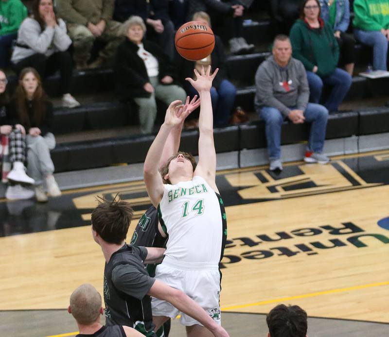 Seneca's Brady Sheedy looks to shoot a shot over Midland's Jacob Spicer during the Tri-County Conference Tournament on Thursday, Jan. 25, 2024 at Putnam County High School.