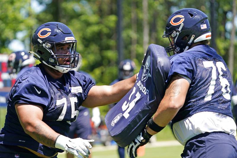 Chicago Bears offensive tackle Larry Borom, left, works with Teven Jenkins during practice June 16 at Halas Hall.