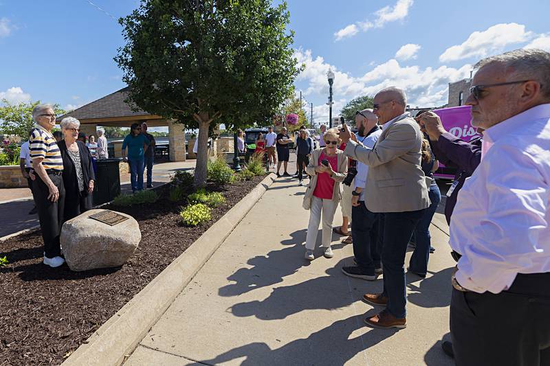 John Groshans with wife LaDonna have their photo taken with the plaque honoring him Friday, Aug. 9, 2024 at Dixon’s Heritage Crossing.