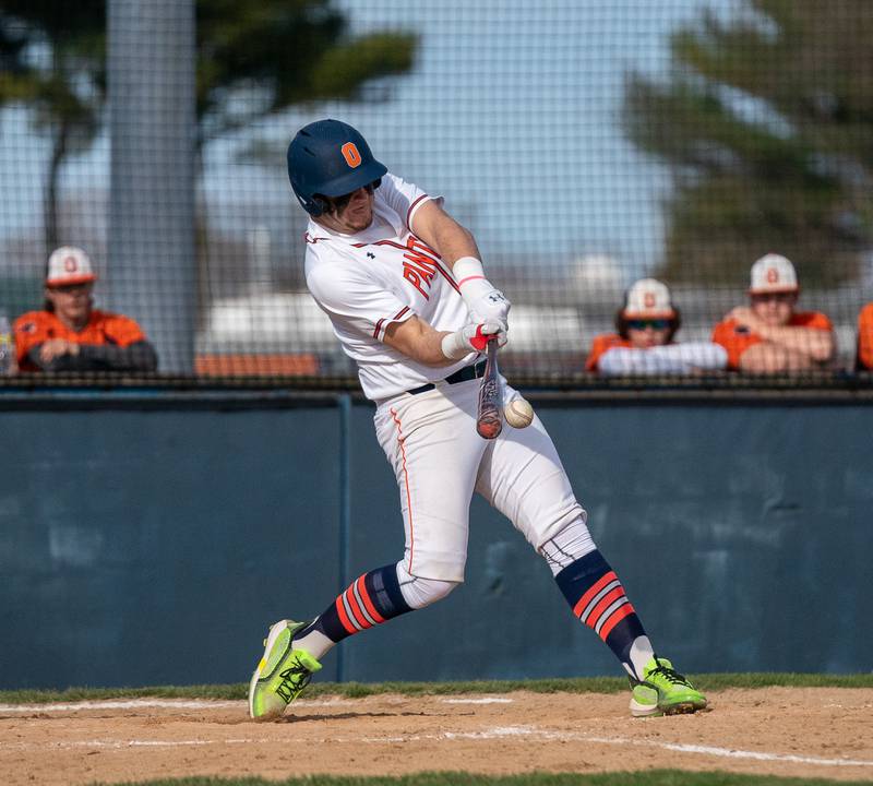 Oswego’s Cade Duffin (30) singles driving in a run against Plainfield South during a baseball game at Oswego High School on Monday, April 11, 2022.