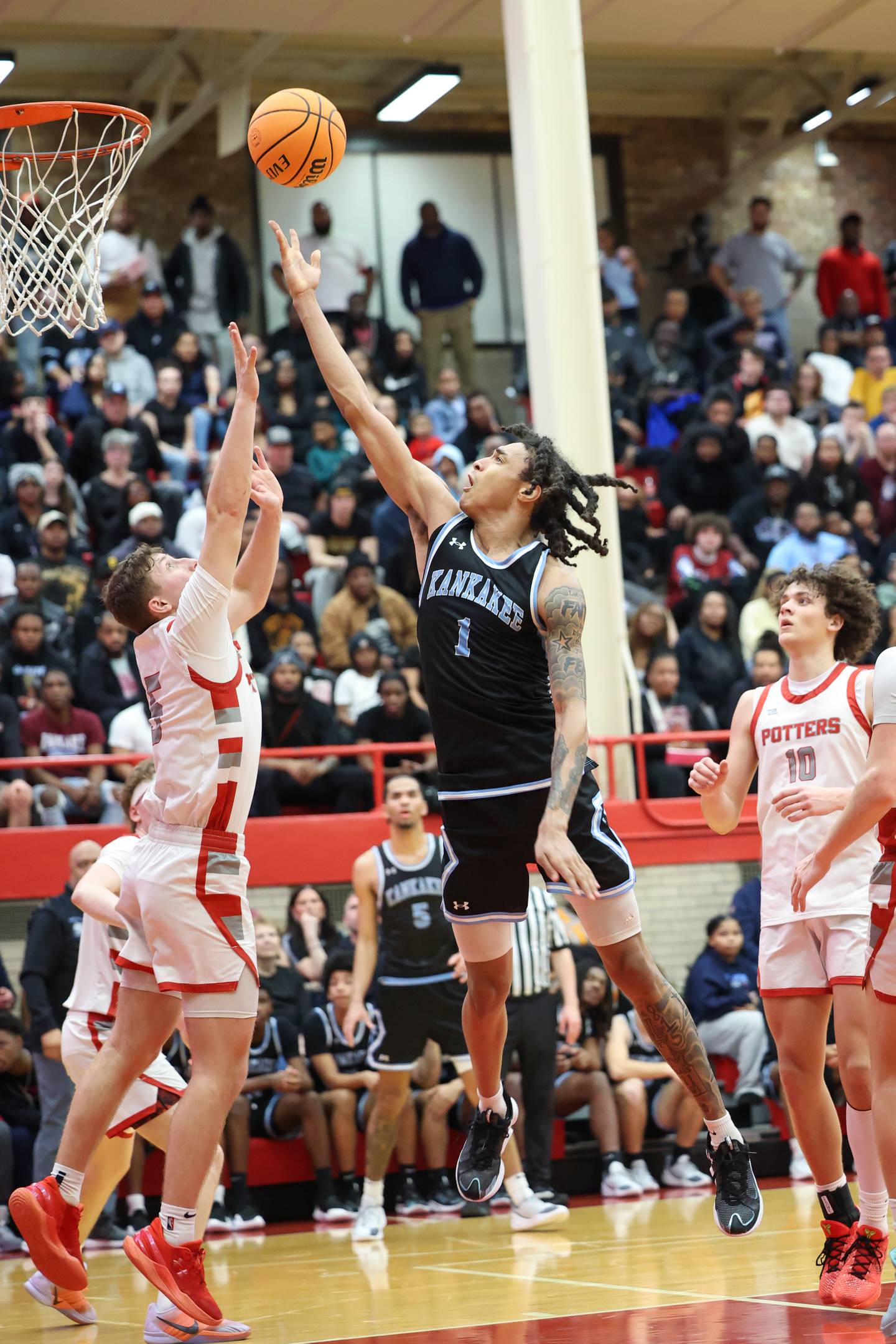 Kankakee's Lincoln Williams tosses up a shot under pressure during the Kays' 61-48 loss to Morton in the IHSA Class 3A Ottawa Sectional championship on Friday, March 6, 2026.