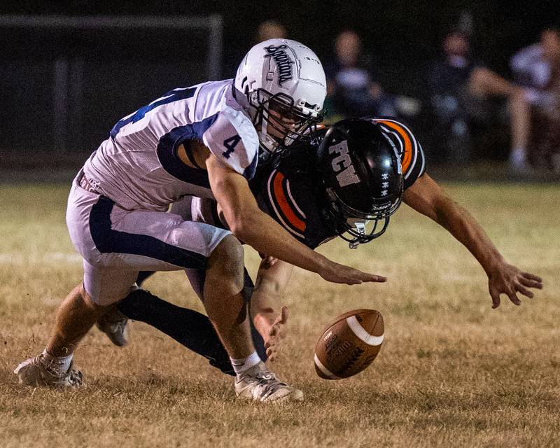 Rob Sandberg (4) of Ridgewood pushes Leelynd Durbin (7) of FCW to floor as they fight over possession of loose ball on Friday, Sept. 26, 2025, at Woodland School in rural Streator.