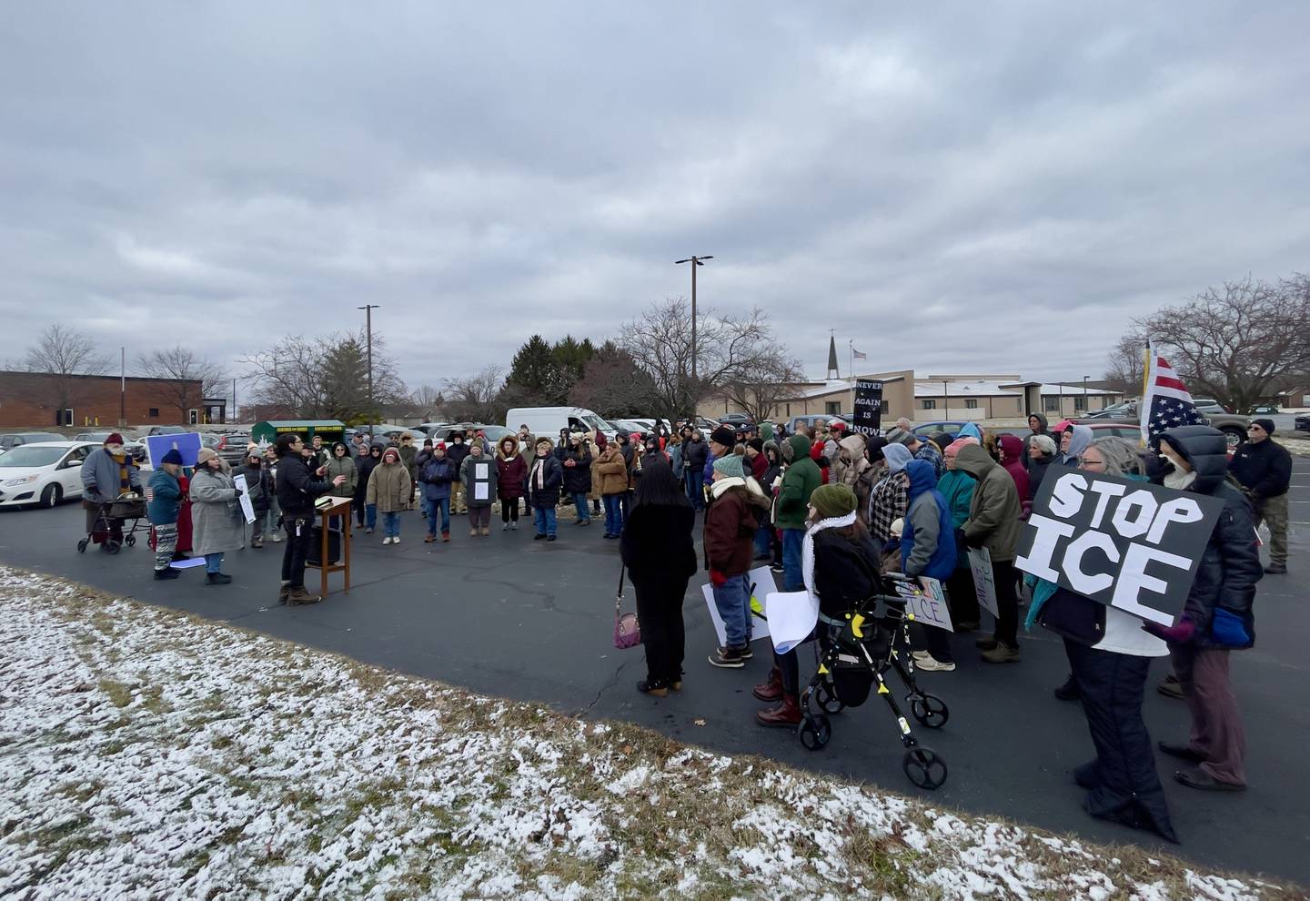 Attendees hold signs as about 100 gathered for an ICE Out for Good protest and vigil at The Grow Center in Bourbonnais on Sunday, Jan. 11, 2026.