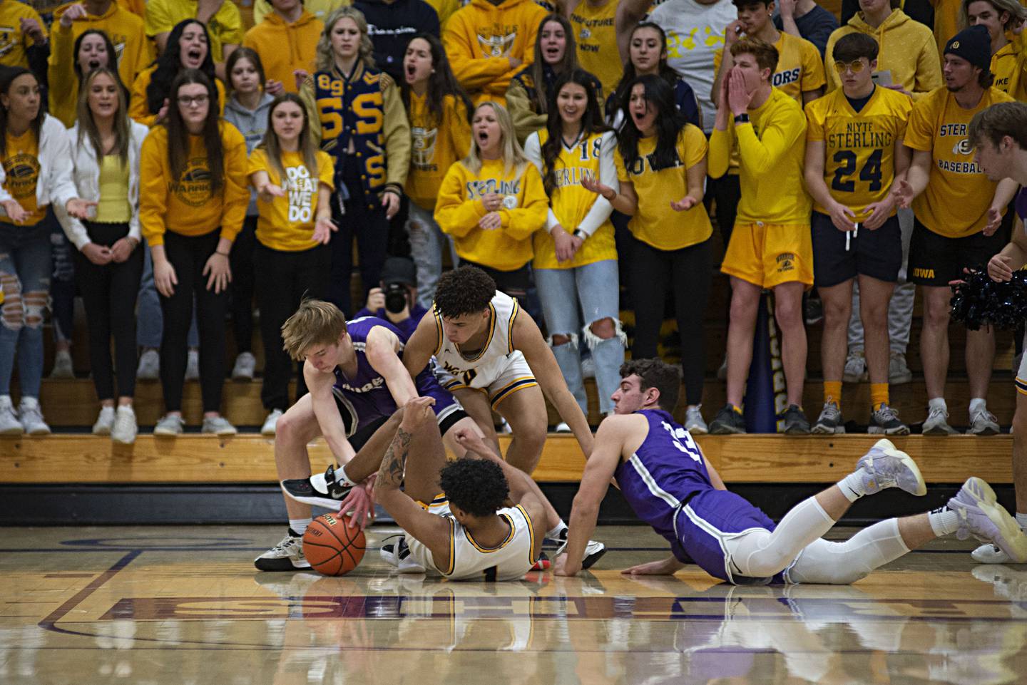 Sterling and Rochelle players grapple for a loose ball in the regional finals Friday, Feb. 25, 2022.