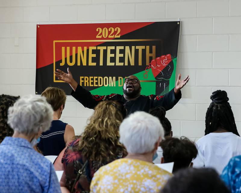 Pastor Michael Henderson of Second Baptist Church in La Grange leads the singing of "Lift Every Voice" during the Juneteenth Celebration in La Grange. June 20, 2022