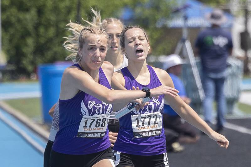 Dixon’s Kait Knipple grabs the baton from teammate Hannah Steinmeyer in the 2A 4x800 Saturday, May 20, 2023 during the IHSA state track and field finals at Eastern Illinois University in Charleston.