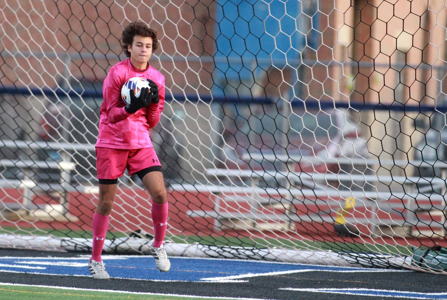 Glenbard West goalkeeper Tobias Montilla makes a save during the Class 3A St. Charles North Sectional semifinal against Geneva on Tuesday, Oct. 29, 2024 in St. Charles.