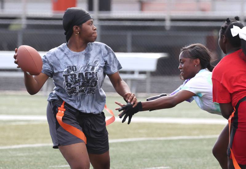 DeKalb’s Angela Gary avoids a pass rusher Wednesday, Aug. 20, 2025, during the first practice of the DeKalb High School flag football team. The squad is preparing for their inaugural season.
