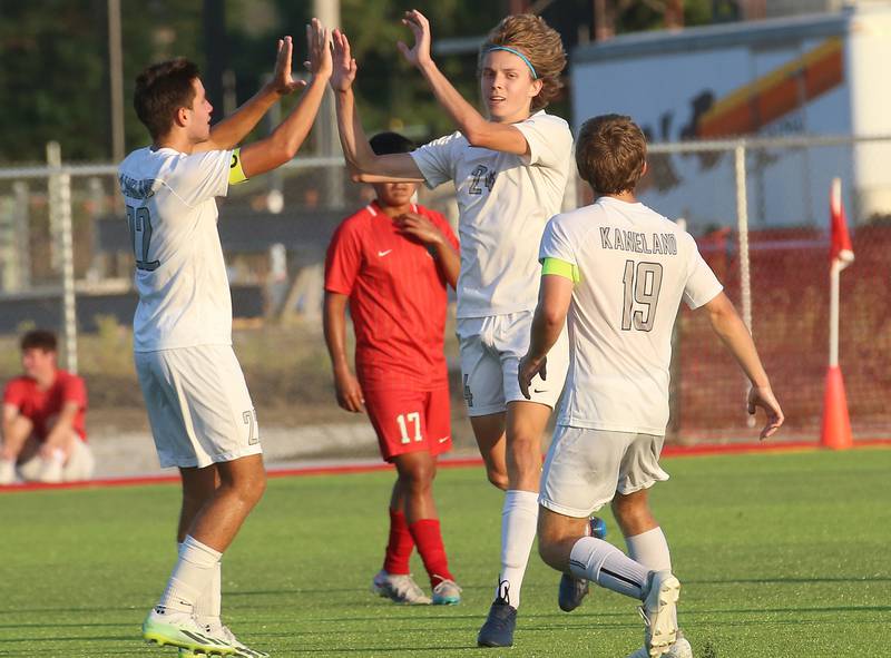 Kaneland players Tommy Watson and Michael Happ hi-five teammate Wilson Love after scoring a goal against L-P on Monday, Aug. 28, 2023 at the L-P Athletic Complex in La Salle