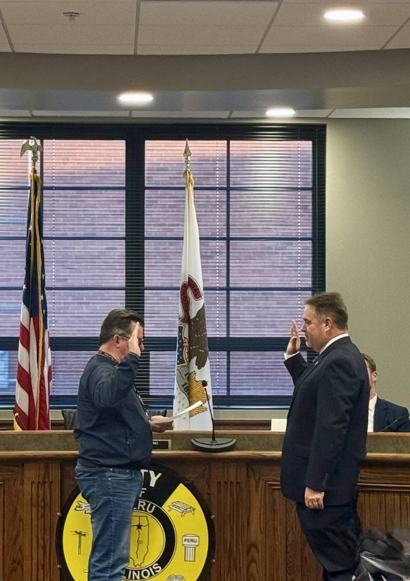 Former City Clerk Dave Bartley swears in new Clerk James "Jamey" Mertel during Monday nights city council meeting. Bartley announced last year he would not be seeking reelection. Bartley has served as city clerk since 2009.