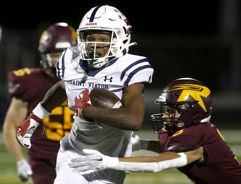 St. Viator's Dayvion Ellis runs through the tackle attempt of Richmond-Burton's Oscar Bonilla during a IHSA Class 4A first round playoff football game Friday, Oct. 27, 2023, at Richmond-Burton High School in Richmond.