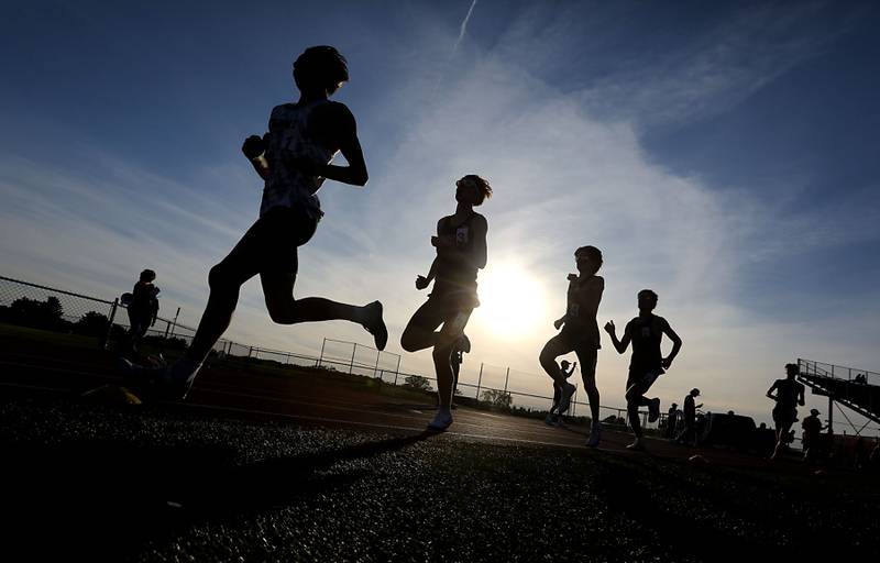 Runners compete in the 3200 meter run during the Fox Valley Conference  Boys Track and Field Meet on Thursday, May 14, 2026, at Huntley High School.