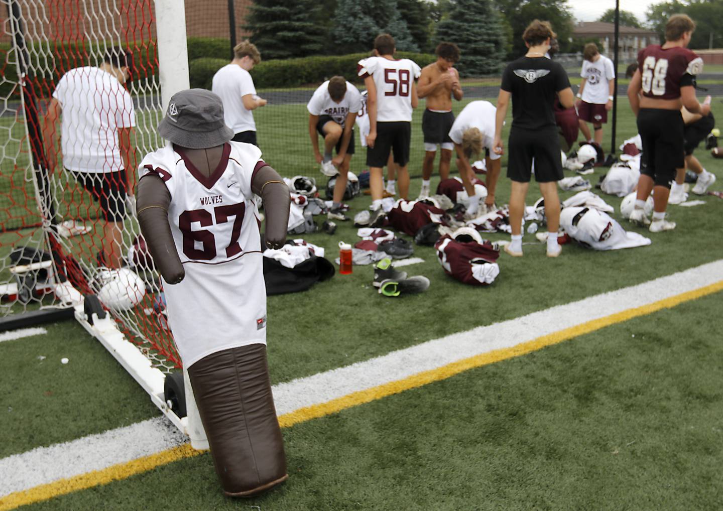 Hermondo, a dummy to symbolize no teammate left behind, sits at the edge of the football field during Prairie Ridge’s practice against Grant on Thursday, July 17, 2025, at Grant High School in Fox Lake.