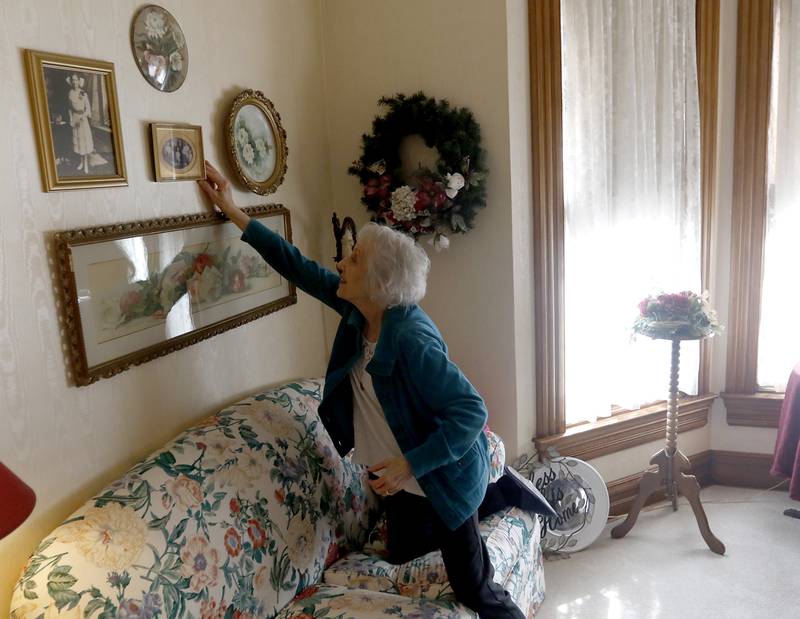 Sherry Brewer, who owns Victorian Rose Garden Bed & Breakfast in Algonquin. adjust a picture on the wall in the B&B on Friday, March 24, 2023. Brewer, who has been running her bed and breakfast since 1995, has seen the area grow and attract more people to tourist-like things, such as bike trails, wine walks, festivals, and car shows.