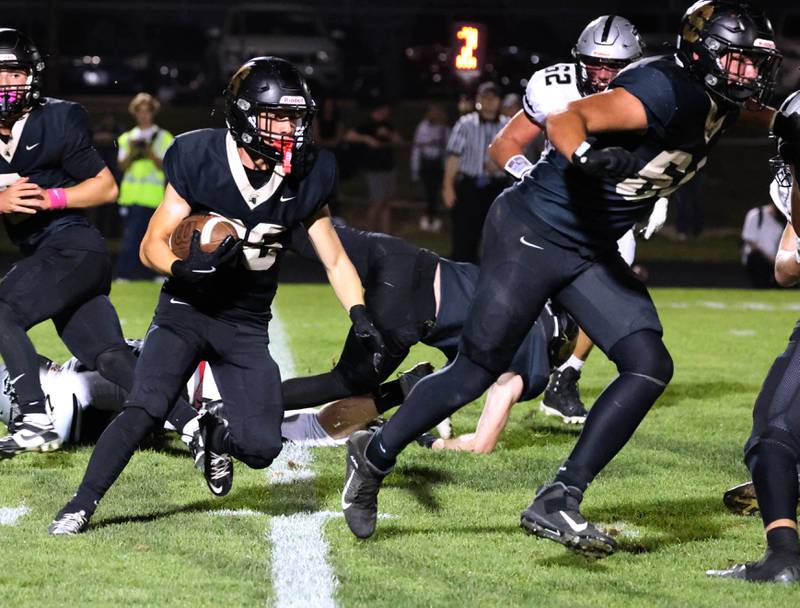 Sycamore's Caden Ralph follows his blockers around the Kaneland defensive line during their game Friday, Oct. 3, 2025, at Sycamore High School.