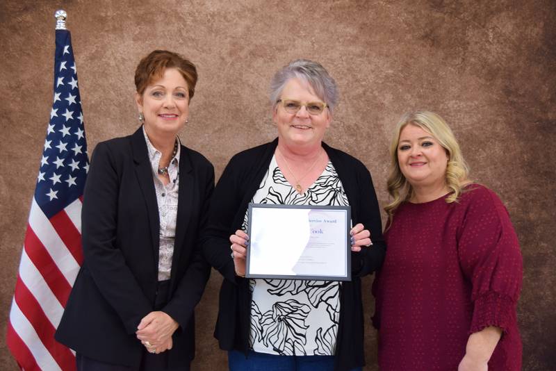 The 2025 Commitment to Service Award was presented to Laura J. Cook, Ogle County clerk and recorder by Zone President Tina Dolder and 17th Judicial Circuit Court Associate Judge Donna Honzel.