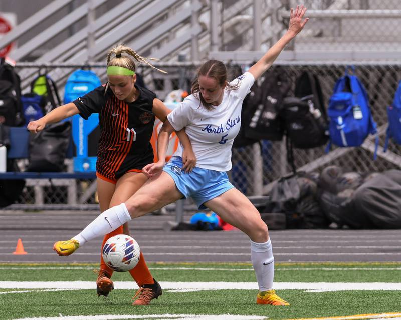 St. Charles East Ella Stehman (11) and St. Charles North Rian Spaulding (5) battle for the ball in the first half of the sectional title game held on Saturday May 27th at West Chicago Community High School.