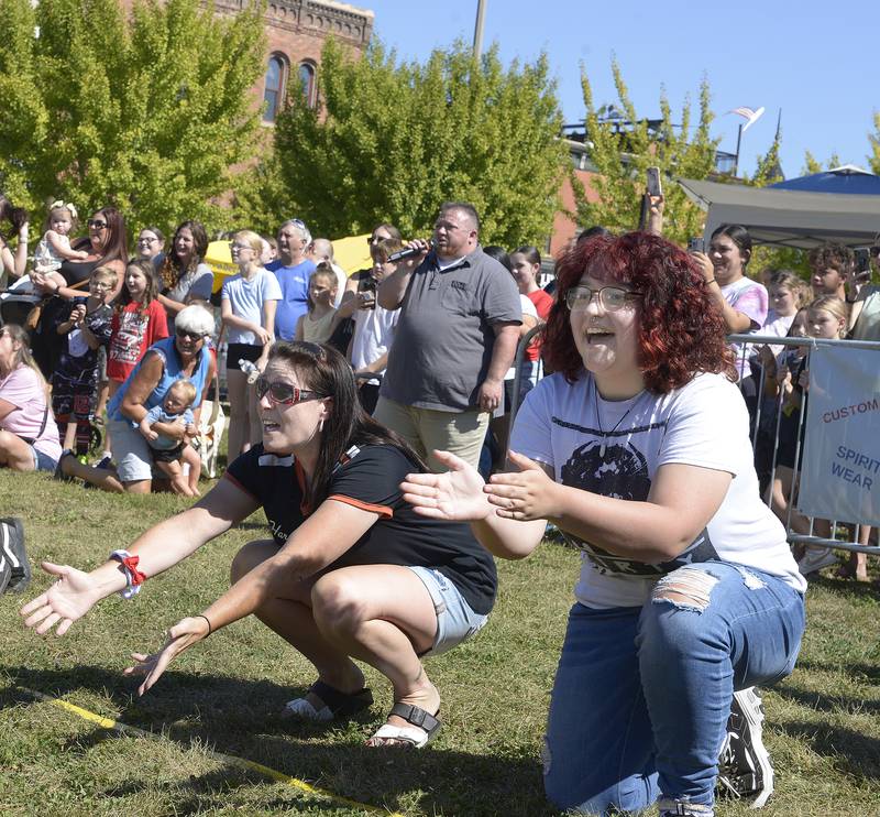 Dachshund owners try to encourage their pets to cross the finish line Saturday during the Wiener Dog Races. The event was part of Ottawa’s Oktoberfest on the Jordan Block.