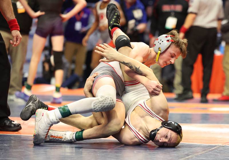 Ottawa’s Ivan Munoz (bottom) wrestles Morton’s Harrison Dea in the Class 2A 106 pound 5th place match in the IHSA individual state wrestling finals in the State Farm Center at the University of Illinois in Champaign.