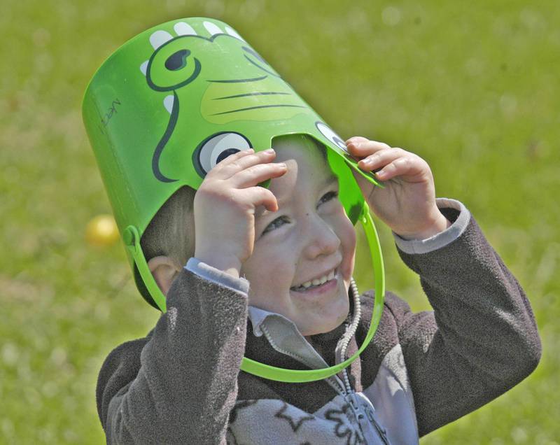 Three-year-old Neal Nusbaum of Sterling plays a game of peek-a-boo with his egg basket. The Eggstravaganza Egg Hunt, sponsored by the Dixon Park District,  took place at the park facilities on Saturday, April 12, 2025.