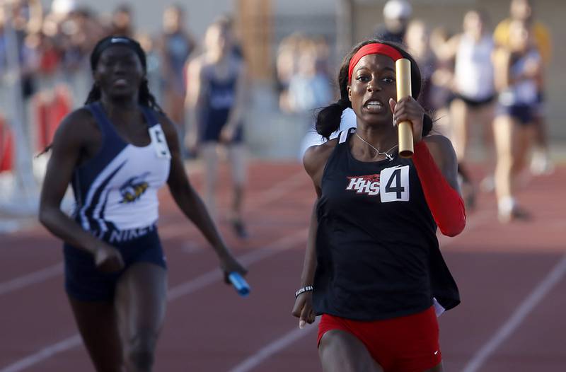Huntley's Alexandria Johnson runs through the finish line as she anchors the 4x100 meter relay Friday, May 10, 2023, during the IHSA Class 3A Huntley Girls Track and Field Sectional at Huntley High School.