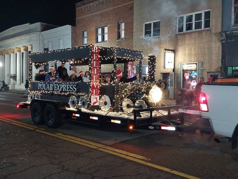 The Polar Express chugs along the Lighted Christmas Parade route Saturday, Dec. 2, 2023, in Peru.