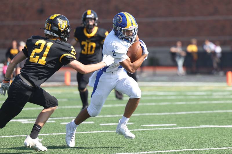 Joliet Central’s Christian Smith heads upfield after a catch against Joliet West on Saturday, Sept. 23, 2023 in Joliet.