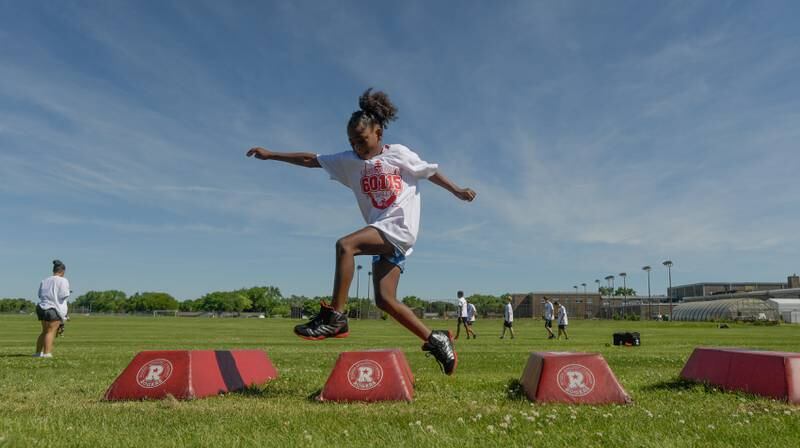 Maya Larson, 8 of Cortland runs a drill during the inaugural Legends of the 60115 Football Camp with NIU’s Cole Tucker in DeKalb on Sunday, June 26, 2022.