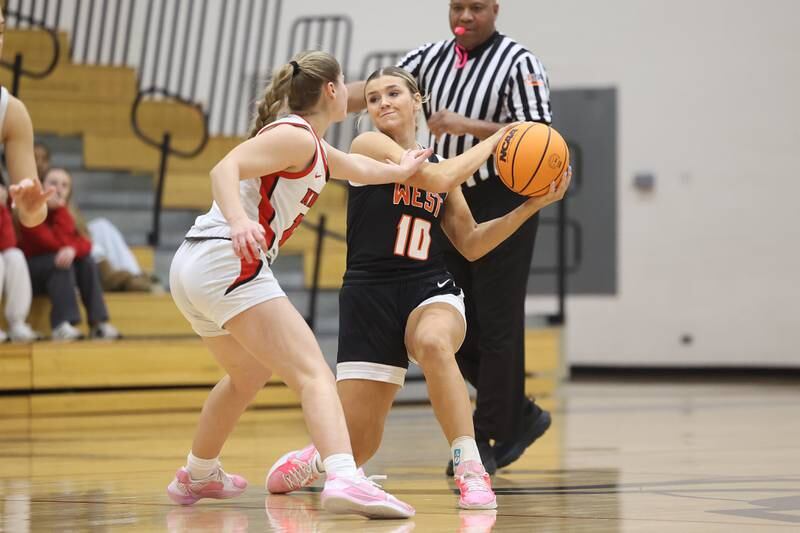 Lincoln-Way West’s Molly Finn works the ball against Lincoln-Way Central on Tuesday, Jan 28, 2025 in New Lenox.