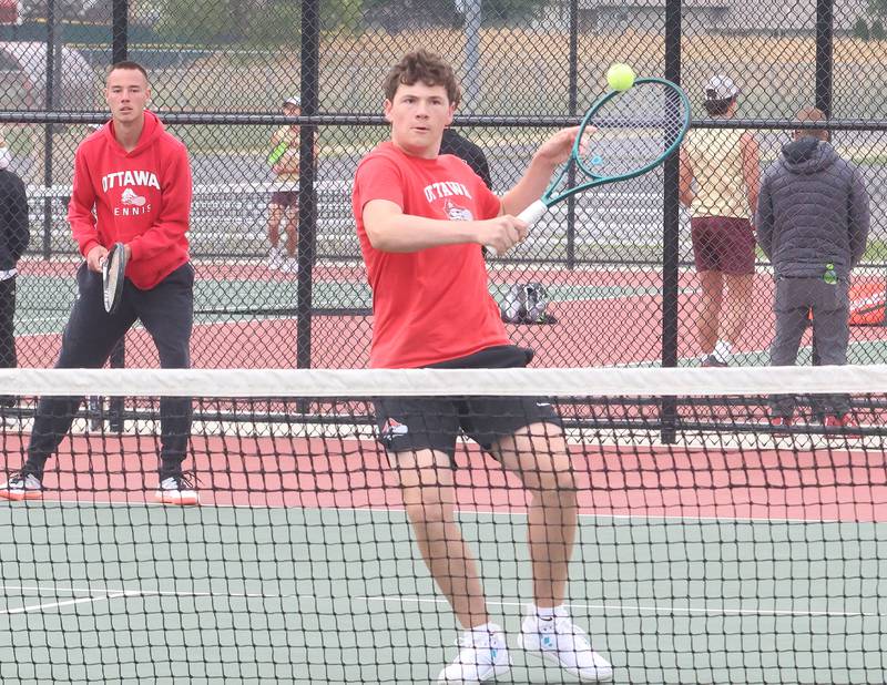 Ottawa's Ayden Sexton returns the ball as teammate Kaden Araujo watches during the Class 1A Sectional tennis meet on Friday, May 22, 2026 at the La Salle-Peru Township High School Athletic Complex in La Salle.