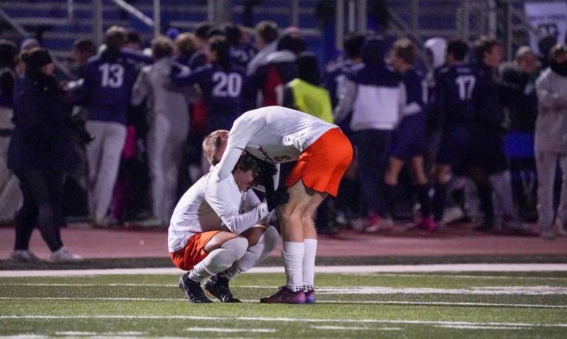 St. Charles East's Marc Walker (right) consoles Giuseppe Avendano after a season ending loss to New Trier for the class 3A St. Charles North Boys Soccer Supersectional final at St. Charles North High School on Wednesday, Nov. 1, 2023.