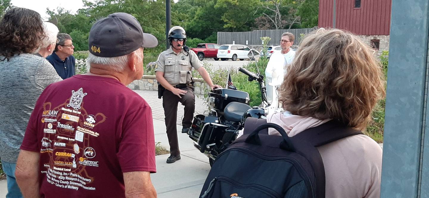 Conservation District Police Sergeant Ben Wolfe provides a police motorcycle unit demo to volunteers at a SWEEP meeting in 2021.