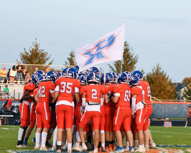 Genoa-Kingston varsity football team huddles at the 50 yard line before they begun the start of the warmups Friday Sep. 16th during a home game while taking on Byron.