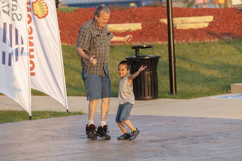 Kevin Kaecker of Rock Falls dances with son Emerson, 5, Thursday, June 19, 2025, during the Rock Falls Block Party.